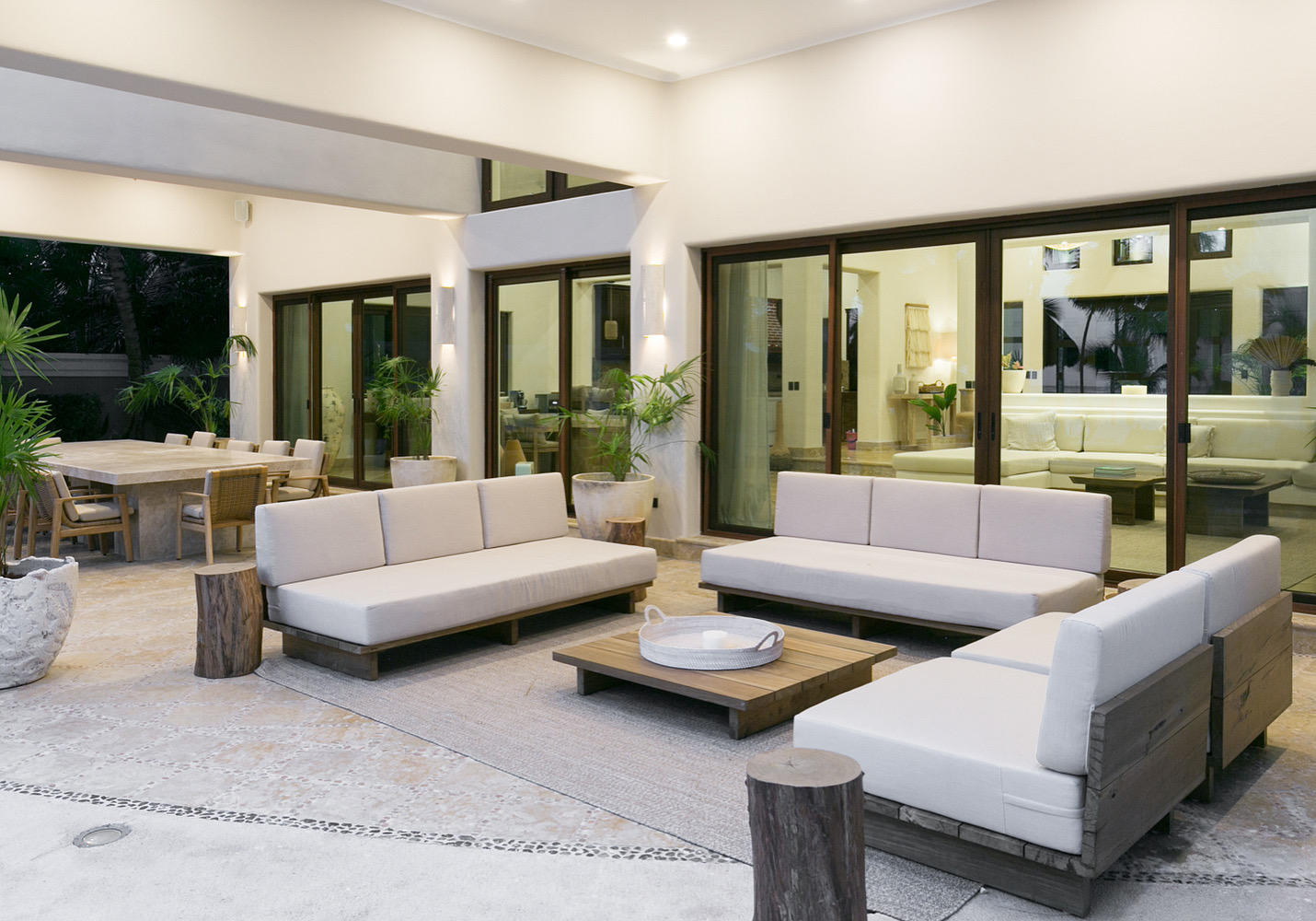The covered patio with lounge seating and the outdoor dining table